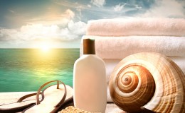 Sunblock lotion and towels and ocean scene
